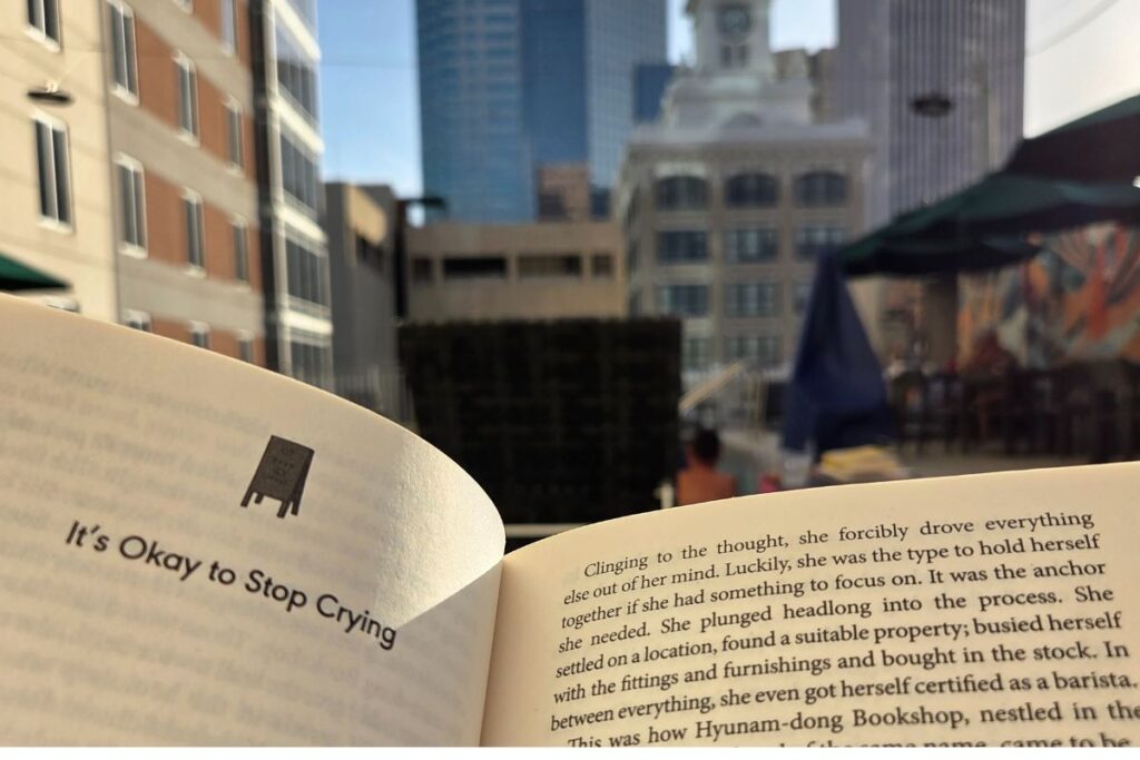 an open book with the city blurred in the background