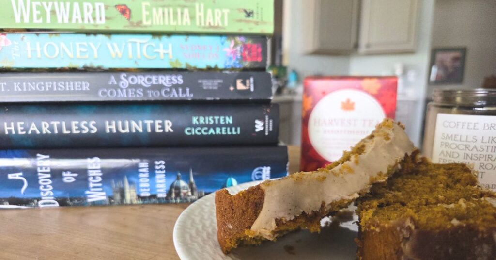 books stacked, pumpkin bread, boxed tea, and candle
