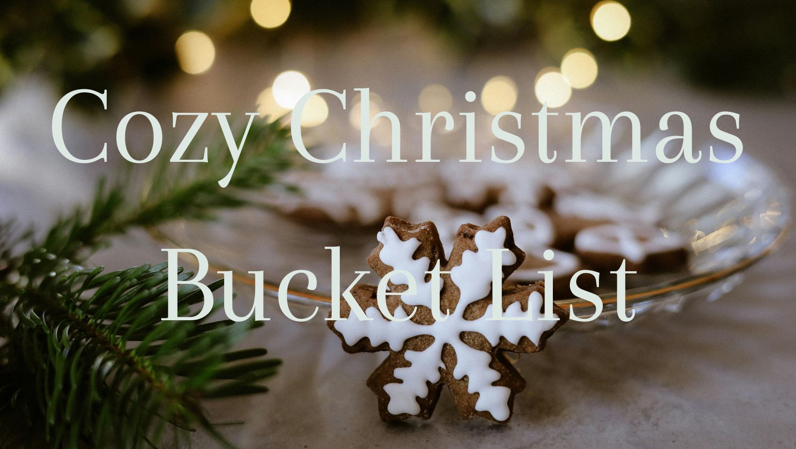 Cozy Christmas Bucket List title with a christmas cookie and lights in the background