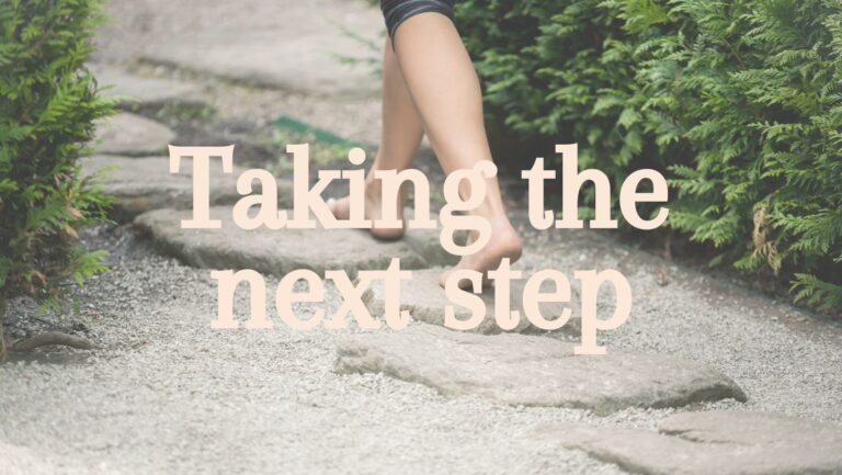 person walking on stones with title taking the next step