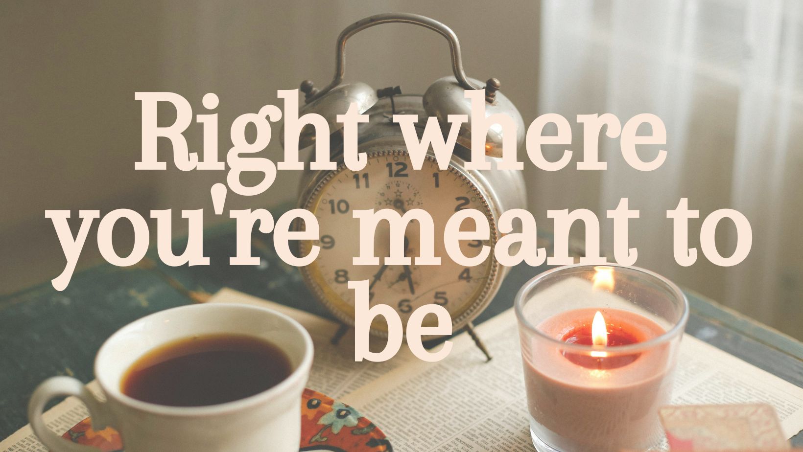 a clock, a coffee cup, and a candle